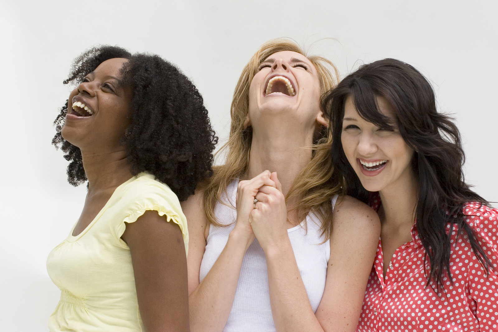Happy diverse group of women laughing and taking.